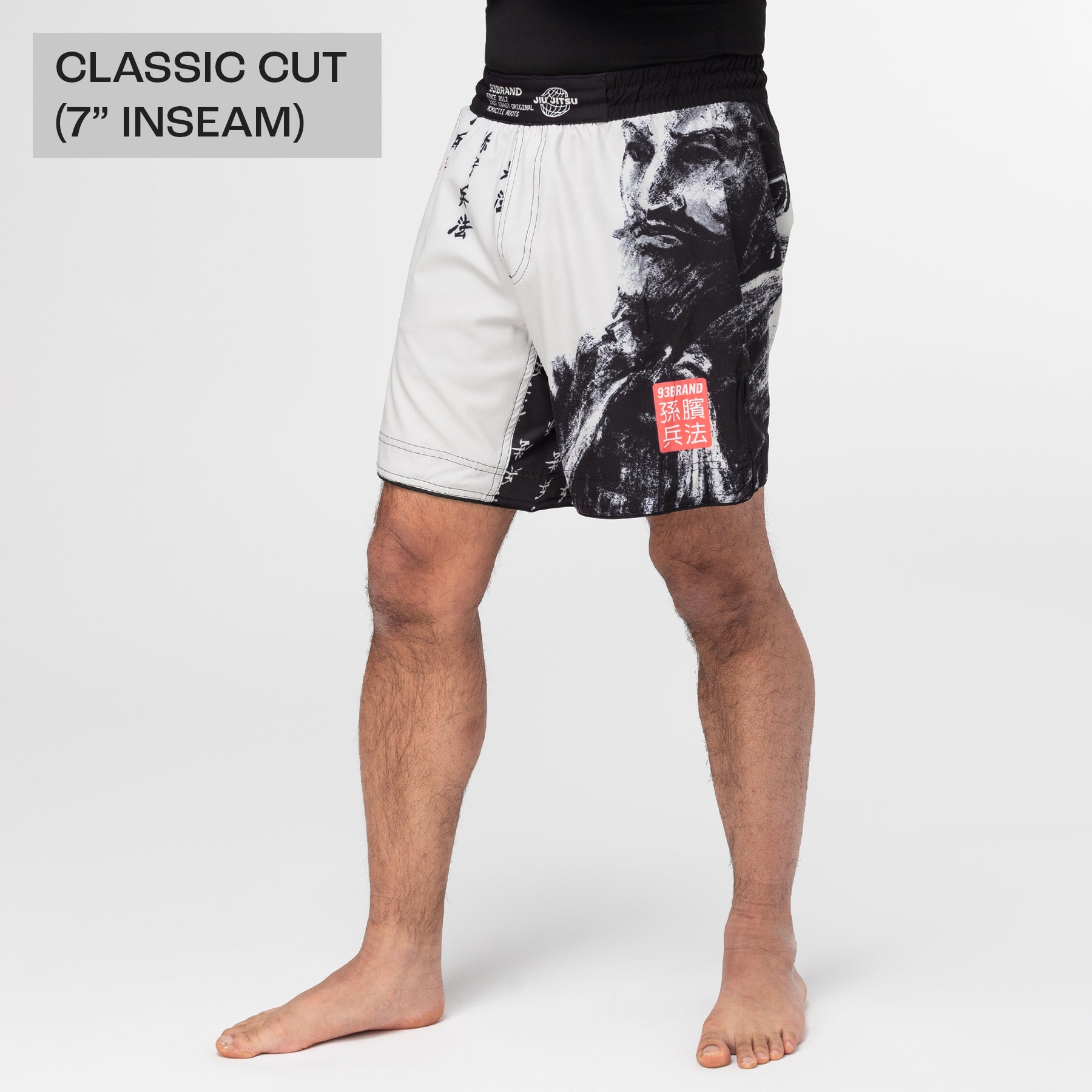 Person wearing black and white graphic shorts on a white background